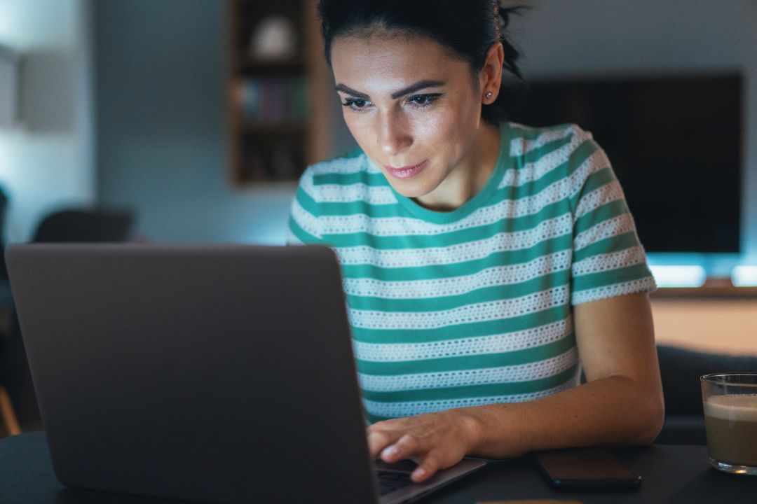 Middle-aged woman working on a laptop at home