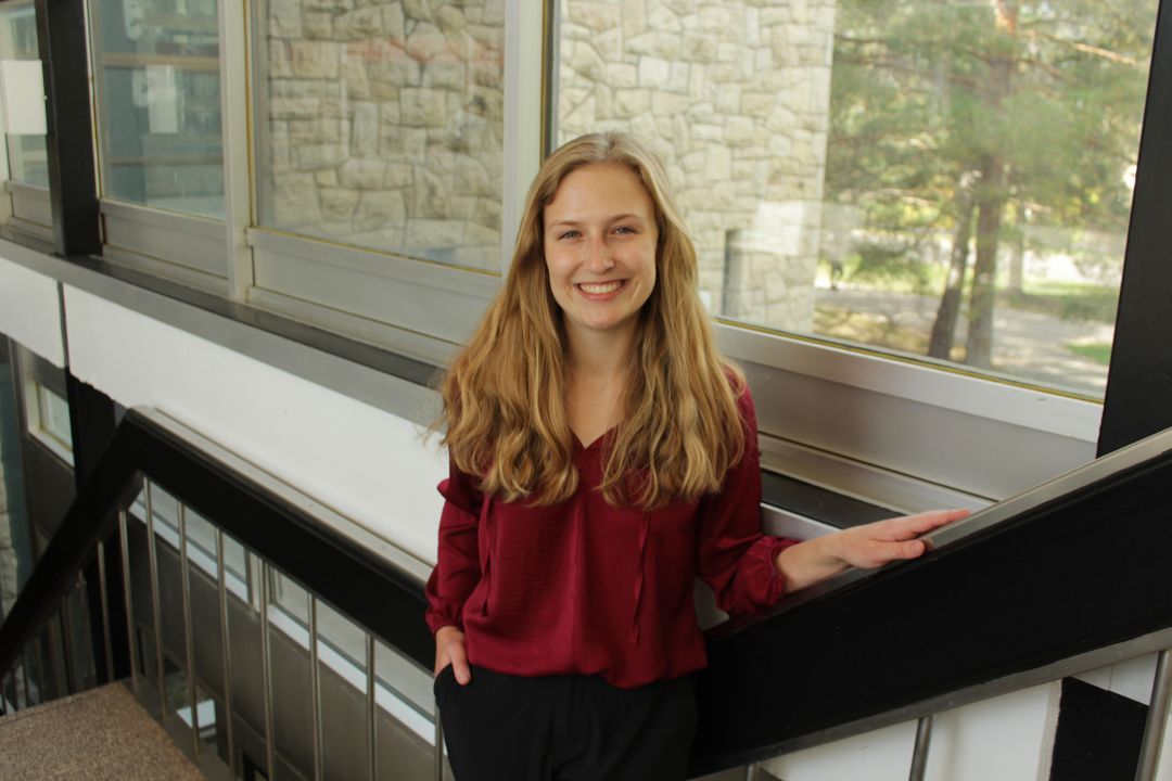 Emma Neufeld stands in the stairwell at the USask College of Law